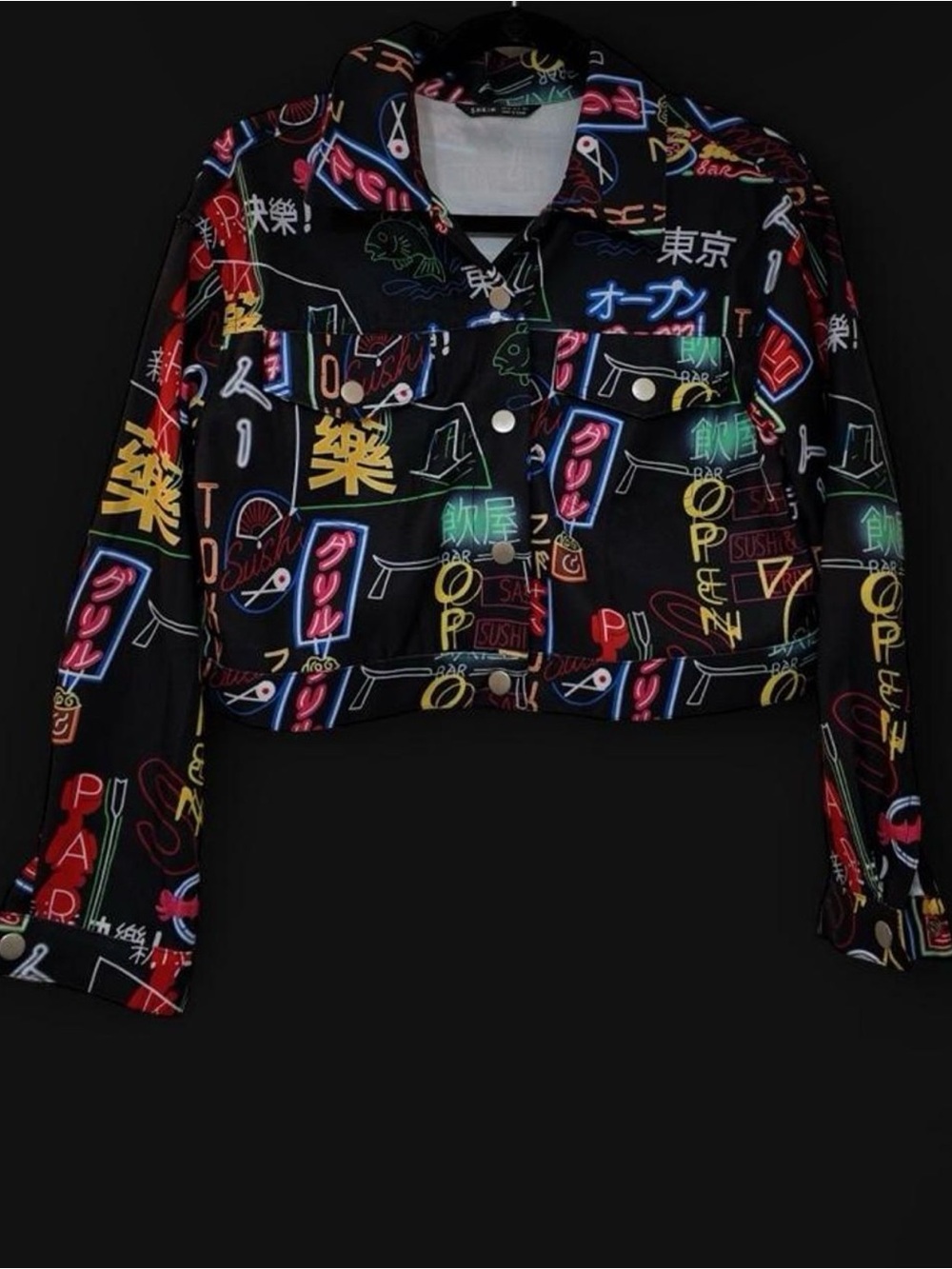 Black cropped jacket with neon style Japanese text and symbols print